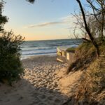 a boat sitting on top of a sandy beach